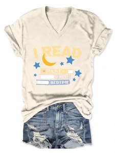 Flat lay of a cream V-neck T-shirt with I Read Past My Bedtime print and denim shorts