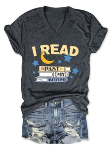 Flat lay of a grey V-neck t-shirt with 'I Read Past My Bedtime' text and denim shorts