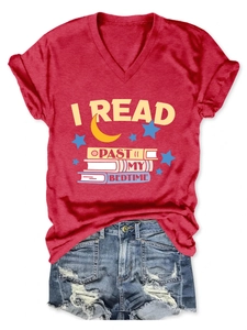 Flat lay of red V-neck T-shirt with I READ PAST MY BEDTIME print and denim shorts