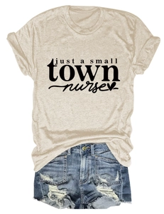 Close-up of oatmeal heather t-shirt with Just a Small Town Nurse print and denim shorts