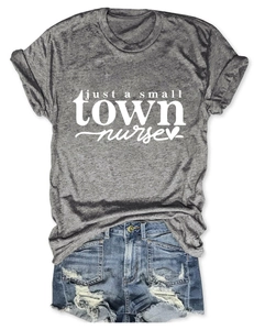 Flat lay of small town nurse grey t-shirt paired with distressed denim fringe shorts
