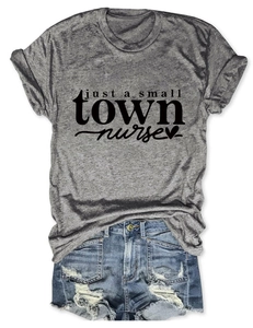 Flat lay of a heather gray nurse slogan T-shirt with distressed blue denim shorts