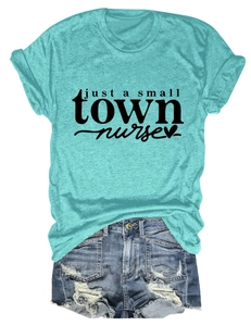 Flat lay of mint green nurse T-shirt with denim shorts showing fabric texture and print