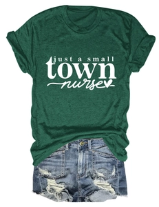 Flat lay of a forest green nurse t-shirt with white script and ripped denim shorts