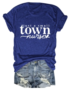 Flat lay of navy blue nurse slogan t-shirt tucked into distressed denim shorts