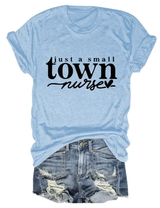 Flat lay of light blue nurse t-shirt with heart graphic and distressed denim shorts