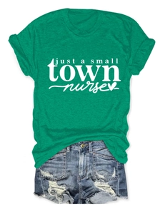 Flat lay of green cotton nurse slogan t-shirt with ripped blue denim shorts