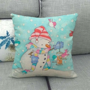 Linen Christmas snowman pillowcase detail with pink scarf and birds on a gray sofa