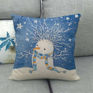 Artistic snowman linen pillow cover on a grey sofa with festive Christmas star patterns