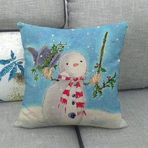 Detail of Christmas snowman linen pillowcase showing fabric texture on a grey sofa