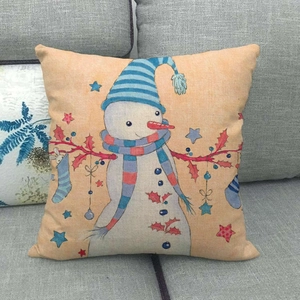 Christmas snowman linen pillow cover with blue hat on grey sofa for home decor