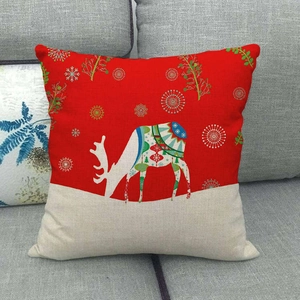 Macro detail of the woven linen texture and reindeer silhouette on the festive pillowcase
