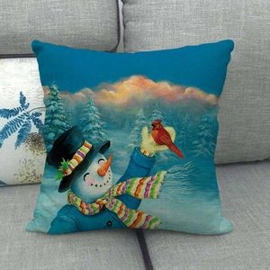 Detailed view of linen snowman pillowcase featuring a red cardinal bird on a sofa