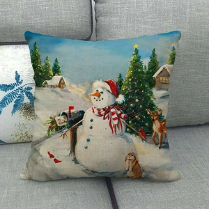 Linen Christmas pillowcase featuring vintage snowman, reindeer, and mailbox print on sofa