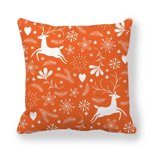 Detailed view of peach skin fabric texture on orange Christmas pillowcase with deer pattern