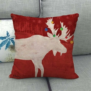Close-up of linen Christmas pillowcase with a red reindeer and colorful ornaments