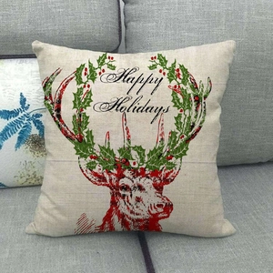 Linen Christmas pillow case with reindeer and Happy Holidays text on sofa