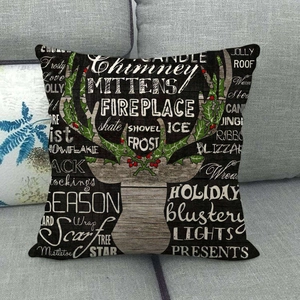 Christmas reindeer horn linen pillow case with holiday words on a grey sofa