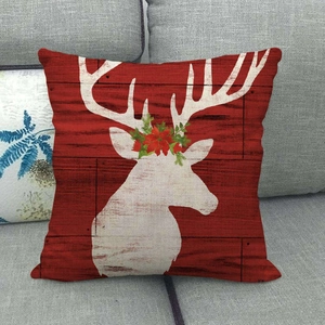 Christmas linen pillow cover with white reindeer silhouette on red wood grain background