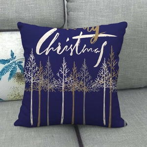 Close-up of a navy linen pillowcase with golden Christmas trees and Merry Christmas text