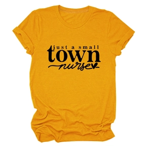 Detail shot of the Just a Small Town Nurse typography and heart on a yellow t-shirt