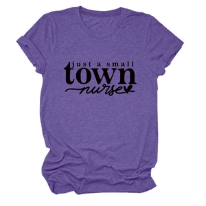 Close-up of purple t-shirt featuring just a small town nurse text and heart icon