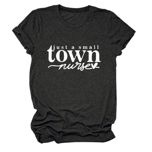 Flat lay of a grey cotton T-shirt featuring a white just a small town nurse graphic print