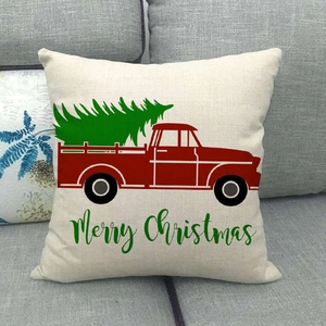 Detail of red Christmas truck print and Merry Christmas text on linen pillow cover