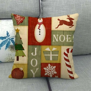 Housse de coussin de Noël en lin avec motifs bonhomme de neige et cerf sur canapé gris