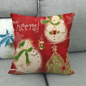 Housse de coussin de Noël en lin avec bonhomme de neige et texte Cheers sur canapé