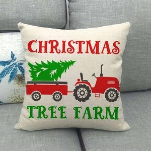 Linen Christmas pillow case featuring red vintage truck and green tree on grey sofa