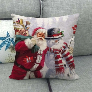Primer plano de una funda de cojín navideña de lino con estampado de Papá Noel y muñeco de nieve