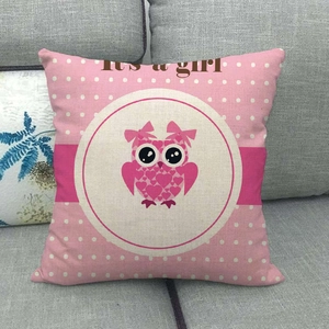 Pink cartoon owl linen pillow cover with It's a girl print on a grey sofa