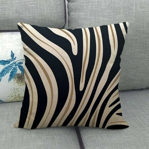 Close-up detail of textured linen pillow cover with black and beige zebra stripe patterns