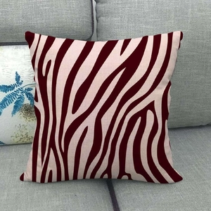 Detail of red zebra pattern linen cushion cover on a grey sofa fabric texture