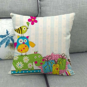 Detail of linen cushion cover with cartoon owl and hippo print on blue striped background