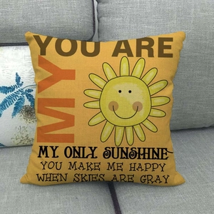 Linen sun pillowcase with YOU ARE MY ONLY SUNSHINE slogan on a cozy grey sofa