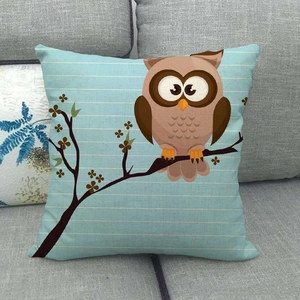 Detailed texture of owl pattern on linen throw pillow cover against a grey sofa