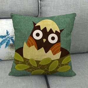 Close-up of linen fabric texture featuring a cartoon owl pattern on a green cushion