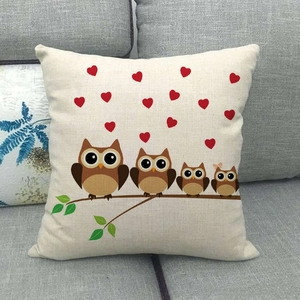 Detail of owl family print on linen pillowcase texture resting on a grey sofa