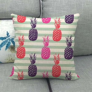 Macro detail of square linen pillow cover with colorful pineapple prints on striped fabric