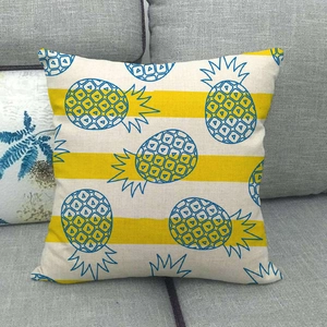 Close-up of linen pillowcase with blue pineapple pattern on yellow striped background