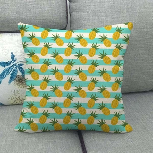 Linen pillow cover with yellow pineapple print on blue and white striped background