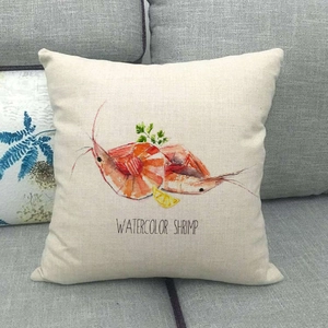 Detail of linen pillow cover with watercolor shrimp and lemon pattern on gray sofa