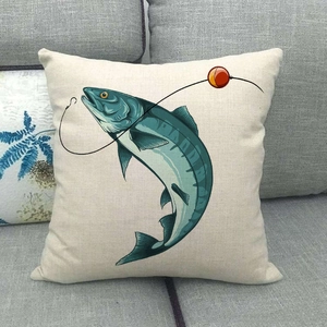 Detailed view of linen cushion cover with hand-drawn fish and fishing lure pattern