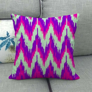 Detail showing the colorful geometric wave pattern on a square linen throw pillow case