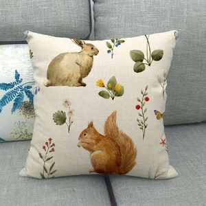 Detailed macro view of linen cushion cover featuring forest animal and floral print
