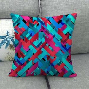 Abstract geometric linen cushion cover with colorful patterns on a gray sofa