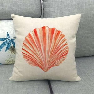 Square linen pillowcase featuring a coastal orange scallop print on a gray sofa