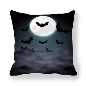 Detail of Halloween pillowcase featuring dark bats flying across a full moon and mist